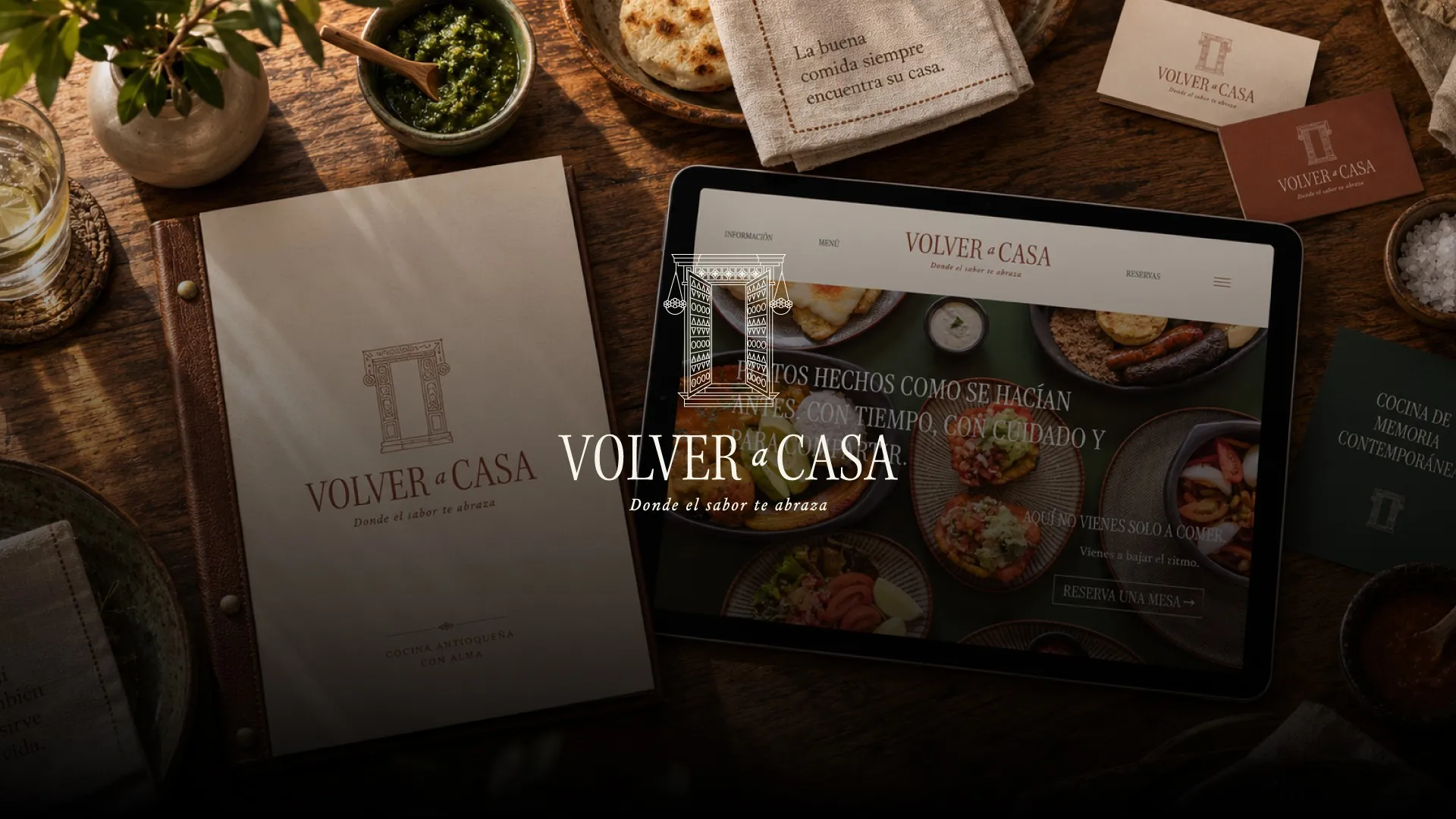 Volver a Casa menu, tablet and logo on a wooden table