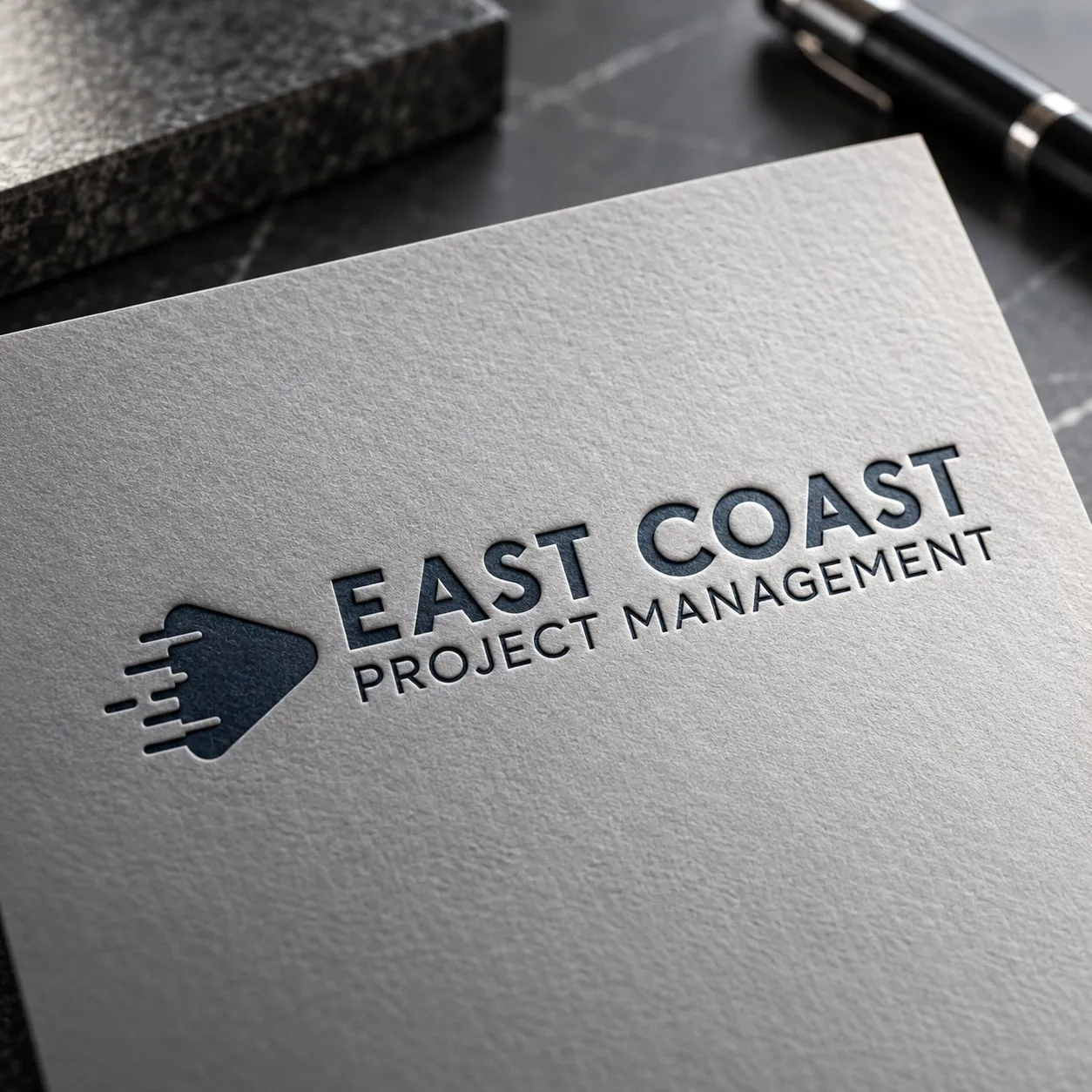 East Coast Project Management logo embossed on gray paper