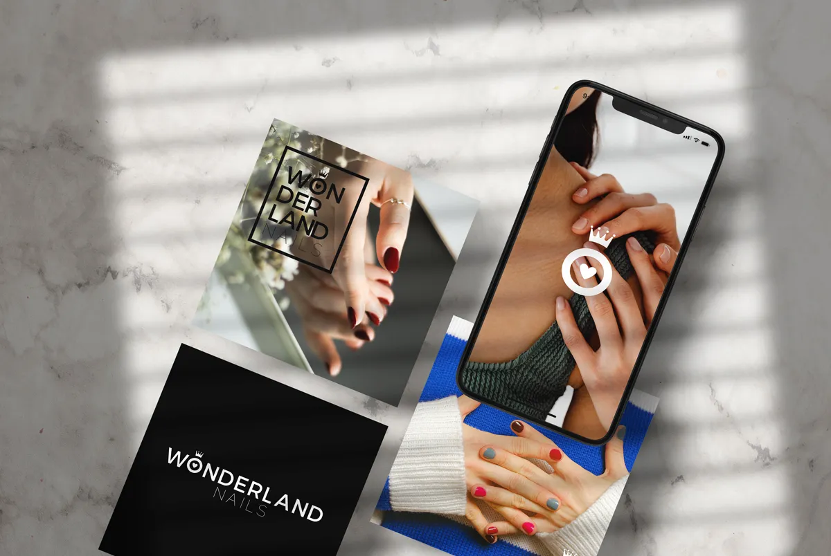 Cards and a phone with photographs of hands and nails in window light